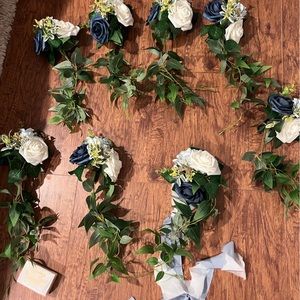8 blue and white flower clips for wedding chair decorations, used once.